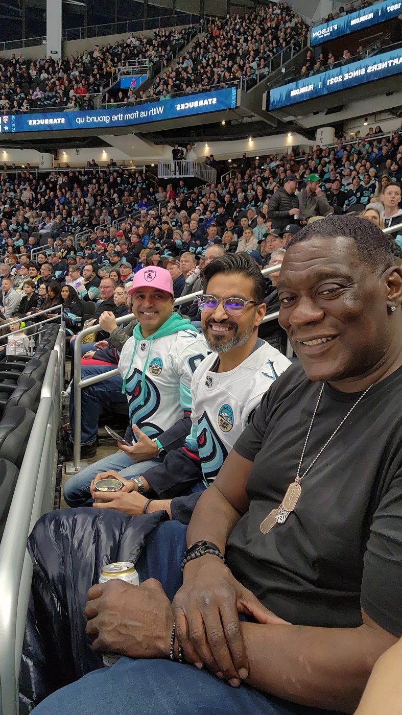 Shawn Kemp with friends in the stands at a hockey game