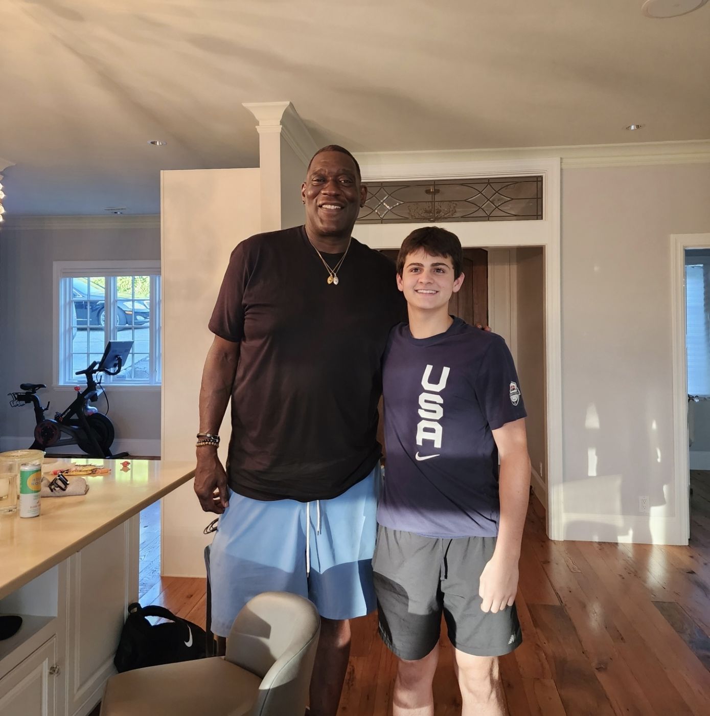 Shawn Kemp standing with a teenage boy in a USA shirt